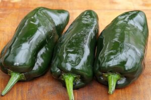 "Roasted poblano peppers with vibrant green skin, rich in vitamins and antioxidants"

