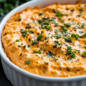 Thick and creamy buffalo chicken dip in a bowl served with celery and tortilla chips